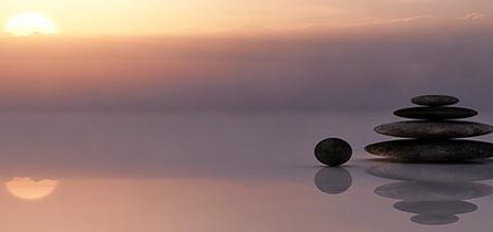 Prayer stones reflected in water