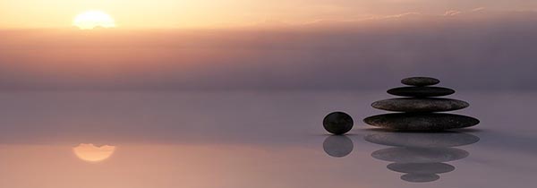 Prayer stones reflected in water