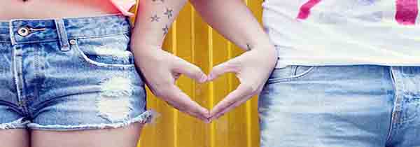Girl and boy s hands joined in heart shape